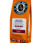 Orange coffee bag labeled 'Planet Bean Coffee' with 'Deep Dark Guatemalan' Ground Coffee on a white background